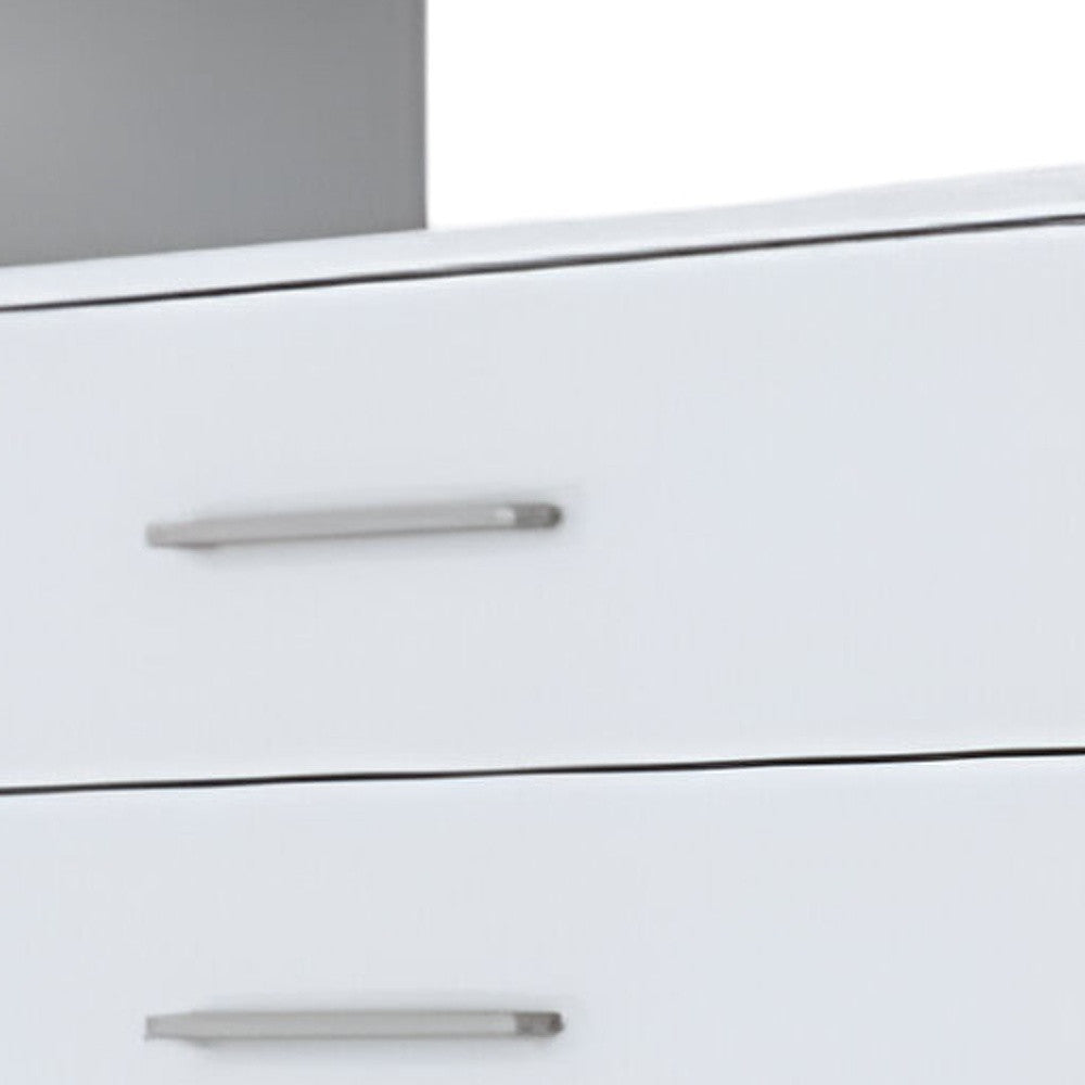 White dresser drawer with silver bar pull, close-up of stacked fronts.