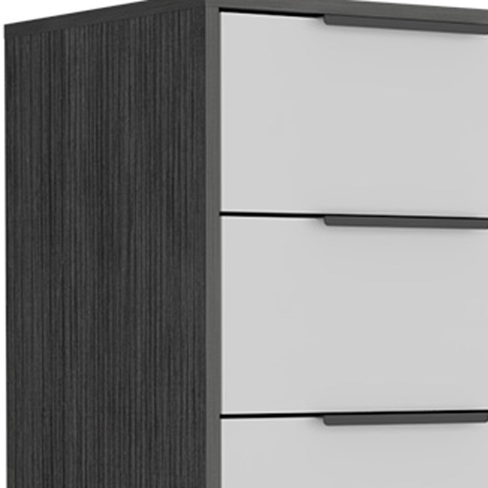 Close-up of white drawers with black bar pulls on dark gray chest