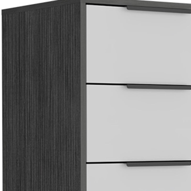 Close-up of white drawers with black bar pulls on dark gray chest