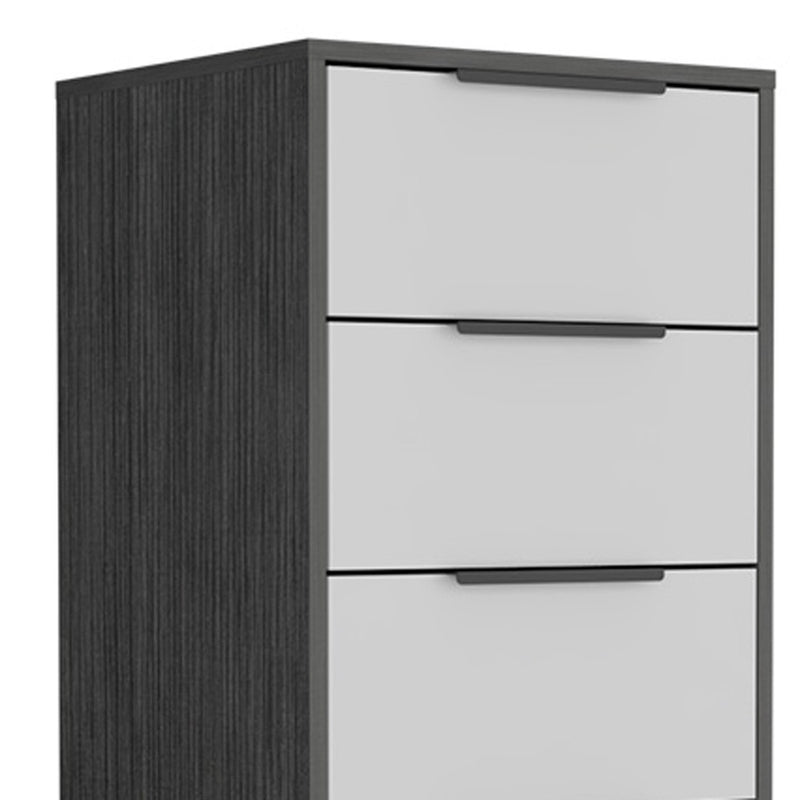 Close-up of dark gray side panel and white drawer fronts with black pulls