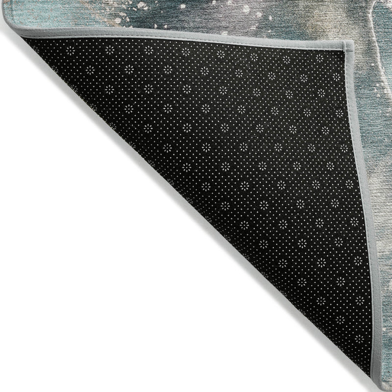Teal rug backing with black non-slip dotted pattern and light gray edge trim