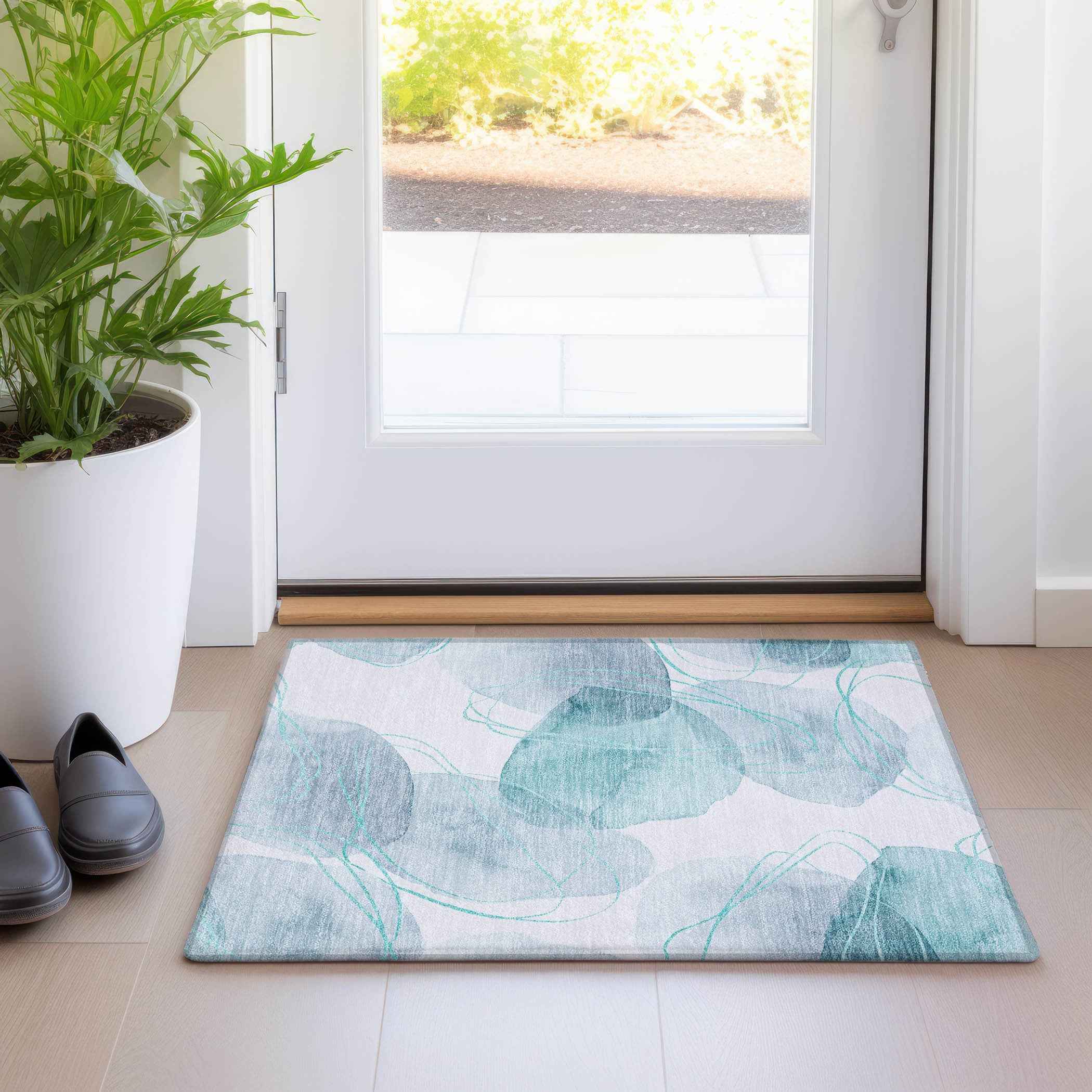 2' X 3' Teal and Ivory Abstract Washable Non Skid Indoor Outdoor Area Rug