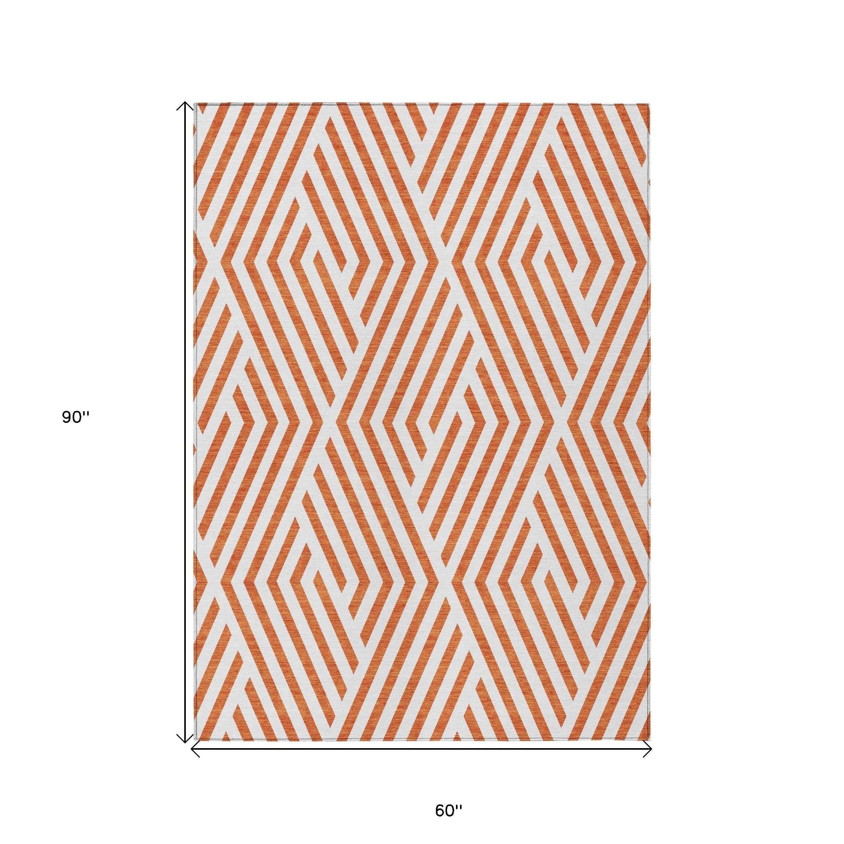 5' X 8' Orange And White Geometric Washable Indoor Outdoor Area Rug