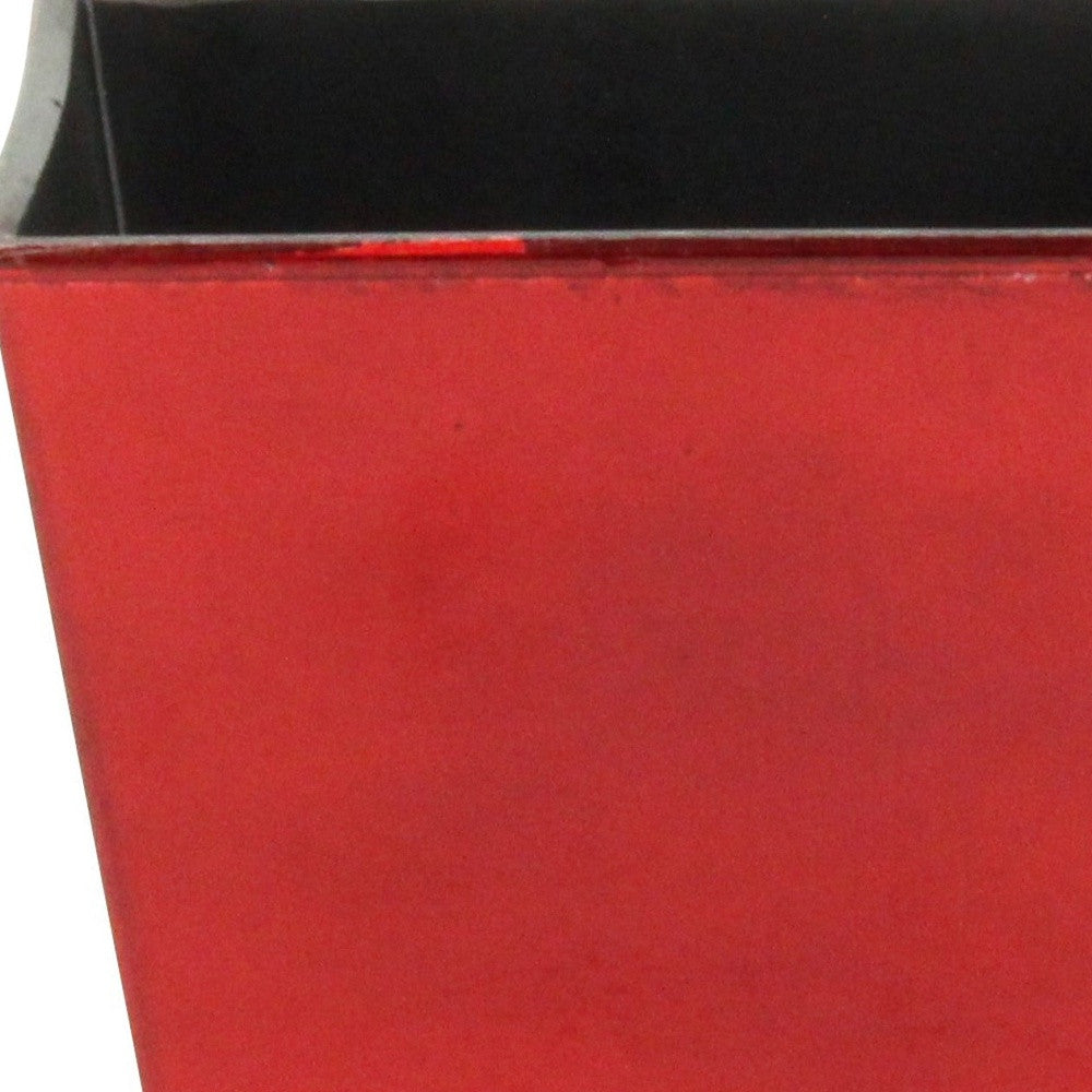 Red square plastic planter with black rim and open top