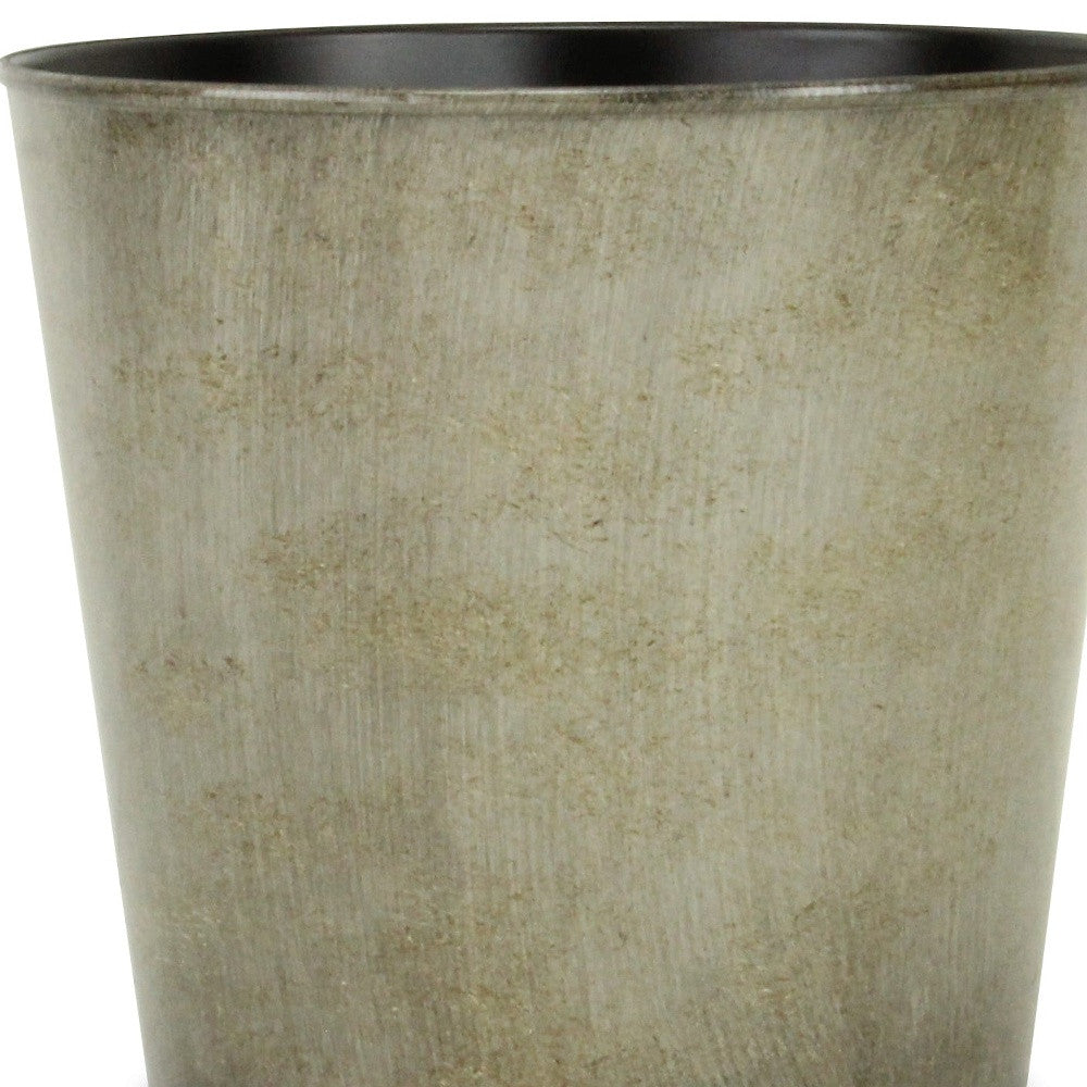 Gray round planter pot close-up showing textured exterior and dark inner rim