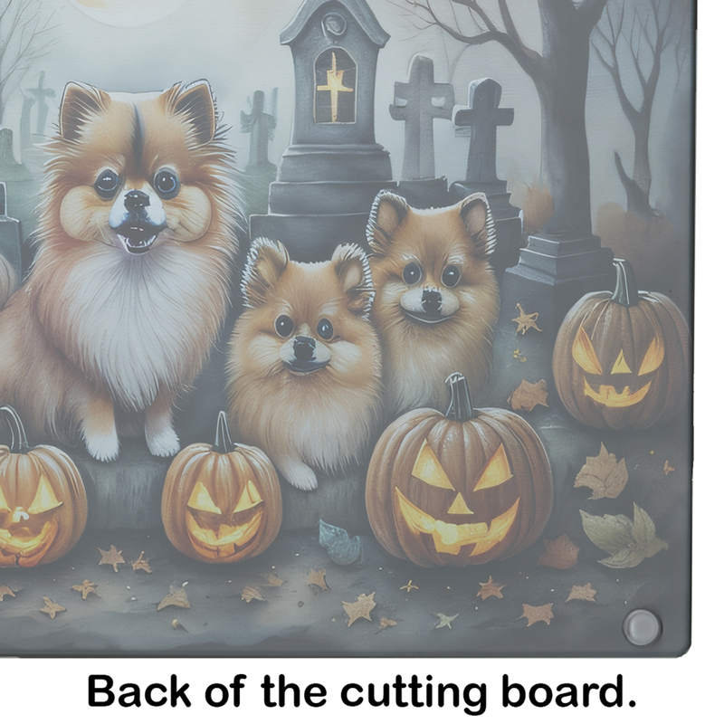 Glass cutting board with Pomeranian pups, pumpkins, and graveyard Halloween scene