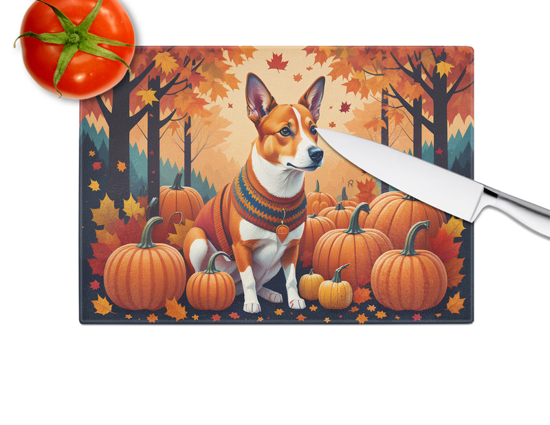 Glass cutting board with basenji dog in fall scene, knife resting on edge