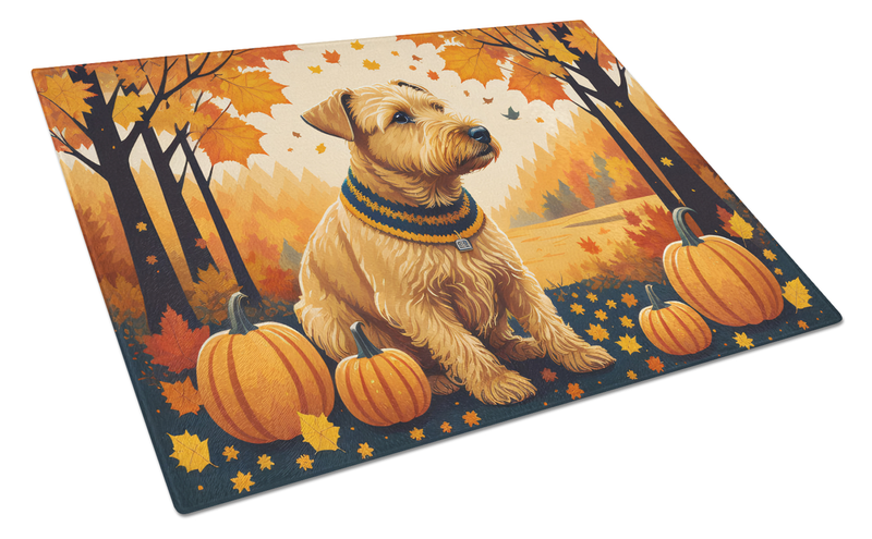 Glass cutting board with terrier in autumn scene, pumpkins, and maple leaves