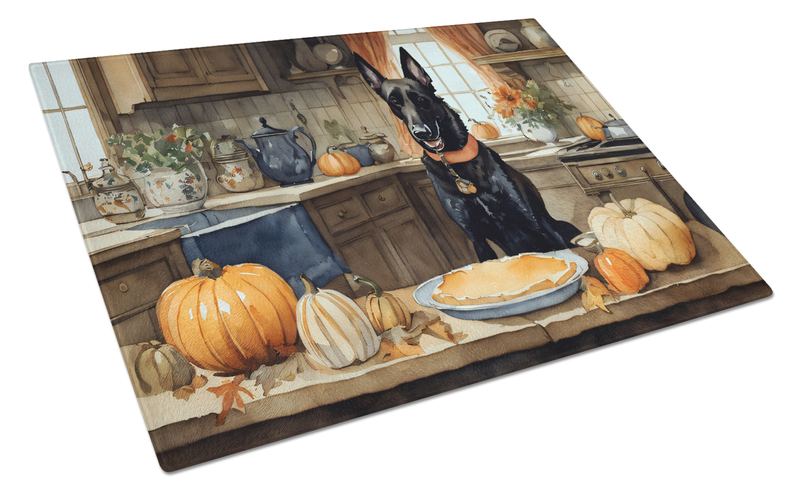 Rectangular glass cutting board with Belgian Malinois, pumpkins, and pie on kitchen ledge