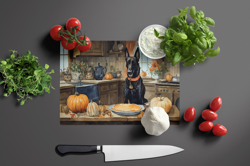 Rectangular glass cutting board with Belgian Malinois and fall pumpkins, styled with knife