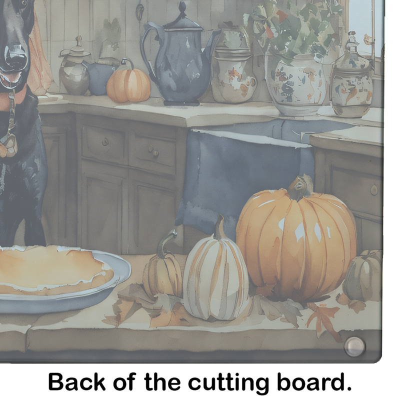 Back of rectangular glass cutting board with fall pumpkins and kitchen utensils print