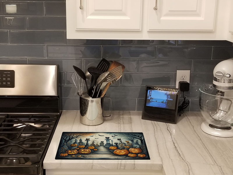 Halloween glass cutting board with cat cemetery stairs, tombstones, and jack-o'-lanterns