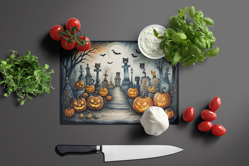 Halloween glass cutting board with cat cemetery pumpkins, bats, and tombstones