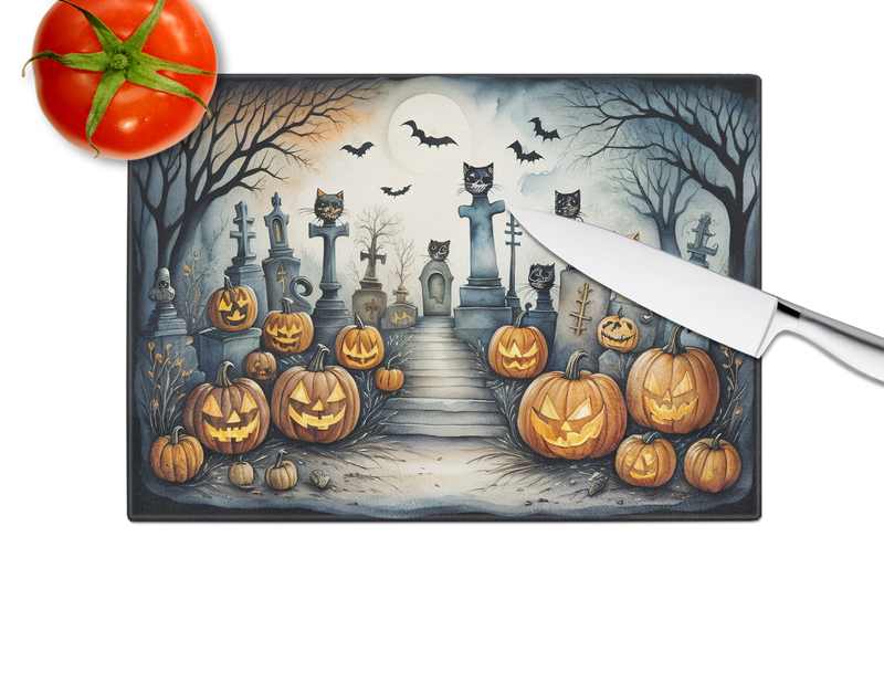 Halloween glass cutting board with cat cemetery scene, tombstones, and jack-o'-lanterns