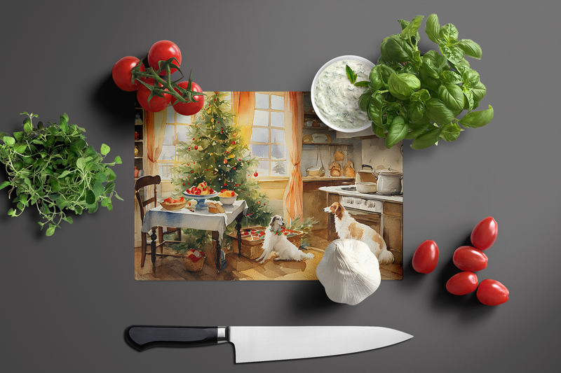 Glass cutting board with festive dog cookie scene, kitchen items styled around it