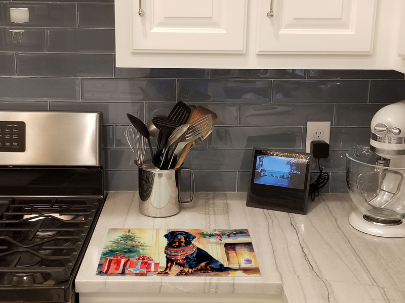 Glass cutting board with Gordon setter Christmas artwork on kitchen countertop
