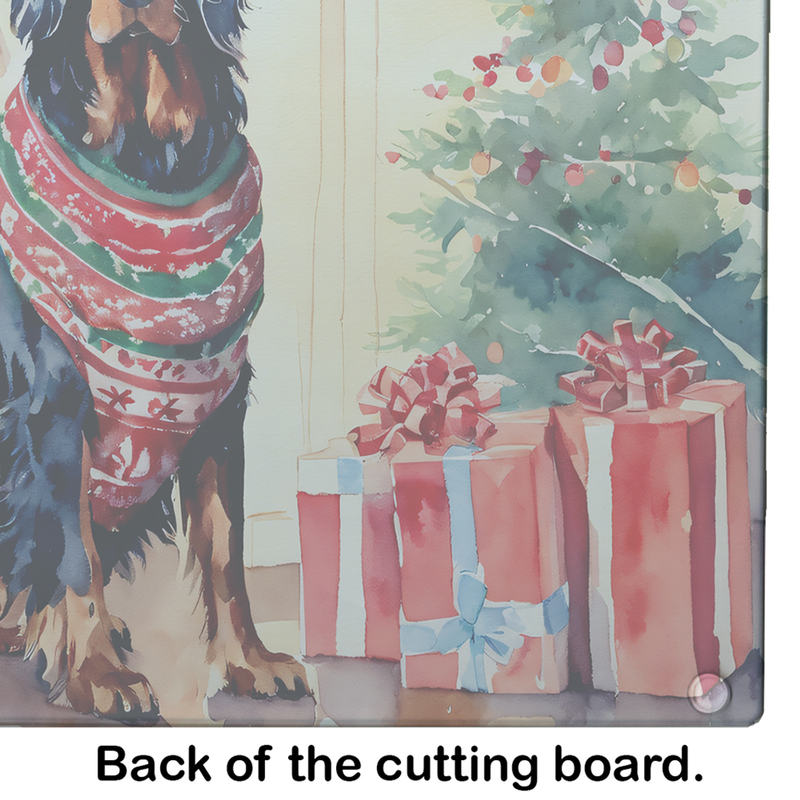 Glass cutting board close-up with Gordon setter in red scarf and wrapped Christmas gifts