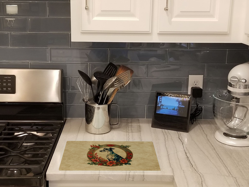 Square glass cutting board with greyhound Christmas flowers artwork on kitchen counter
