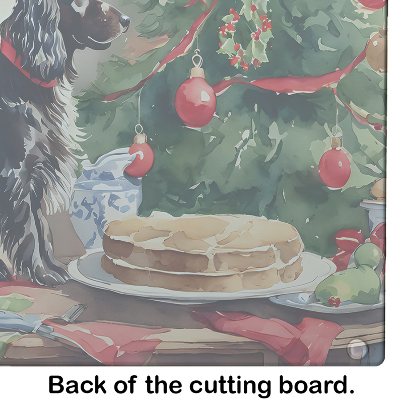 Close-up glass cutting board artwork with cake, Christmas ornaments, and Boykin Spaniel