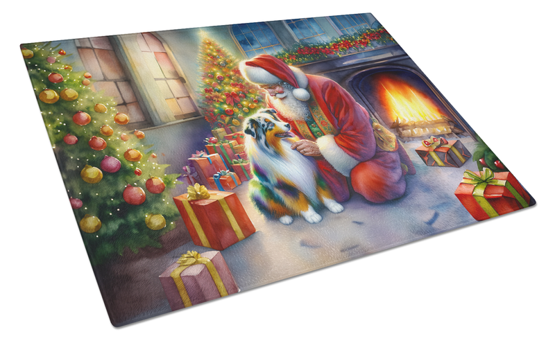 Glass cutting board angled view featuring Santa, an Australian Shepherd, and holiday gifts.
