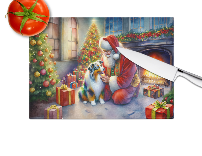 Glass cutting board with Santa and Australian Shepherd, illustrated presents and tree lights.