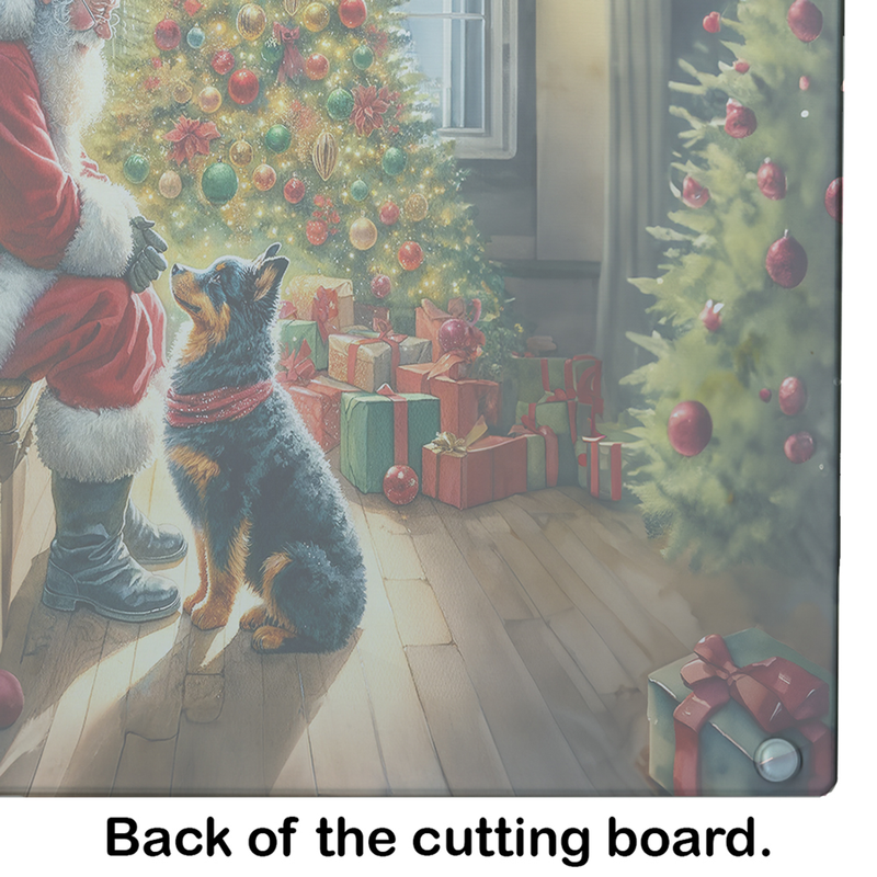 Glass cutting board with Santa and dog beside gift boxes and decorated Christmas tree