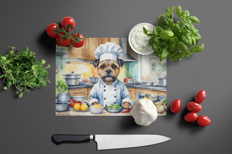 Glass cutting board featuring border terrier chef illustration with kitchen produce