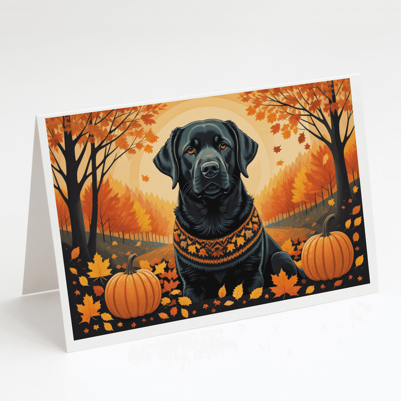 Folded fall greeting card with black Labrador, orange forest background and pumpkins