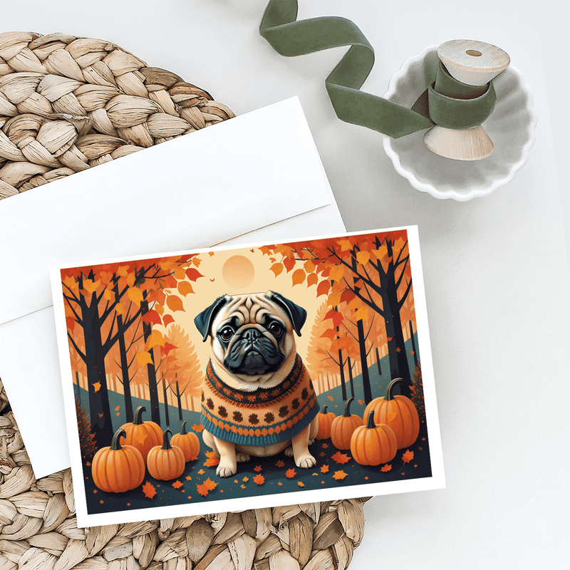 Pug fall greeting card on table with pumpkins and orange foliage