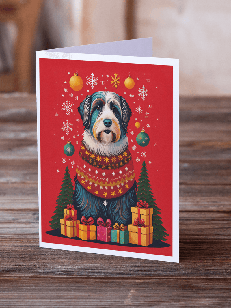Holiday greeting card featuring bearded collie in festive scarf with Christmas ornaments and gifts