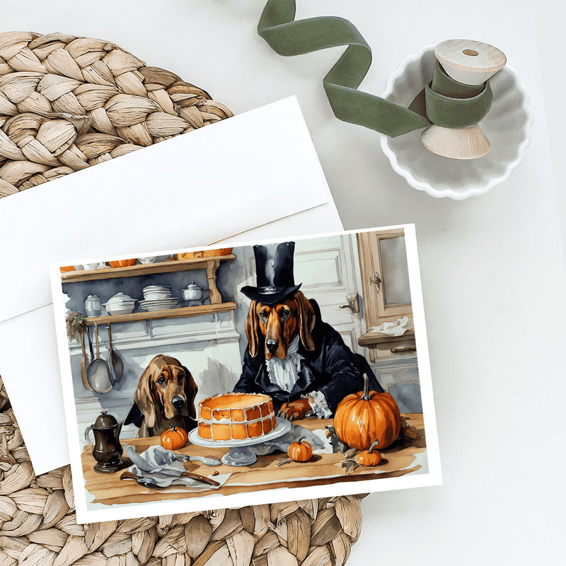 Greeting card showing two dogs at a table with pumpkins and an orange cake