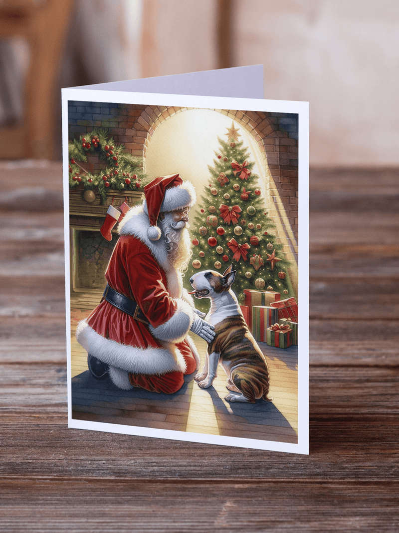 Christmas greeting card on wooden surface, Santa and bull terrier by a decorated tree