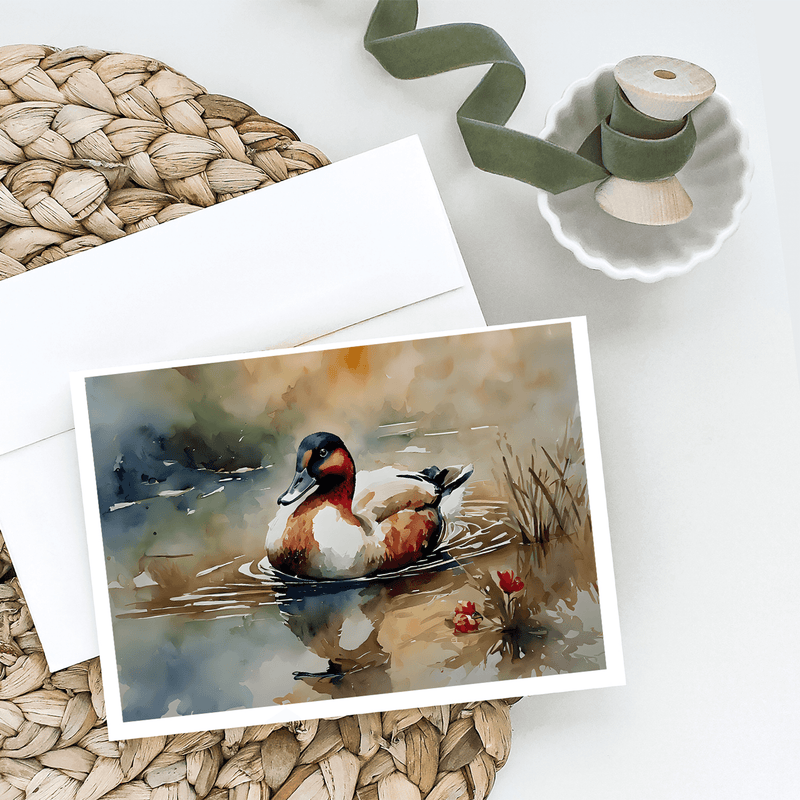 Greeting card with watercolor duck scene, with blank envelope and ribbon nearby