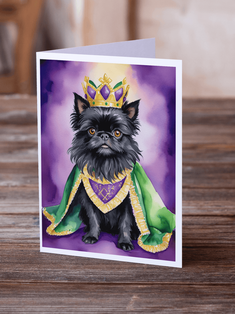 Mardi Gras greeting card with black dog in gold crown and green coat on wooden table