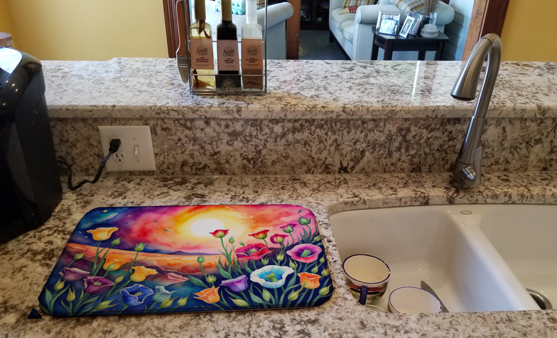 Colorful floral dish drying mat lying on countertop, rounded rectangle shape