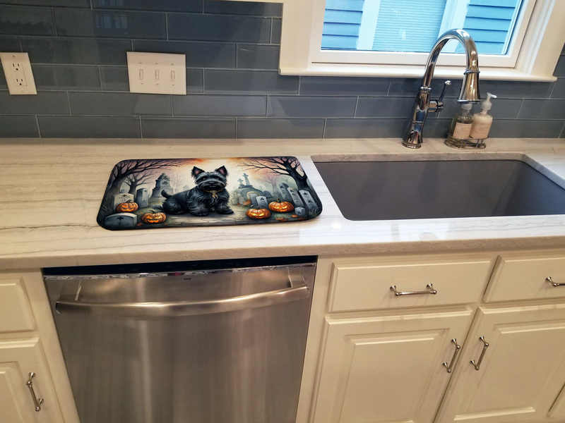 Halloween dish drying mat with black terrier and jack-o’-lanterns on kitchen counter