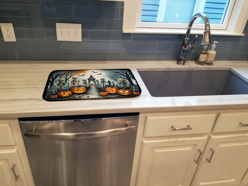 Skeleton Halloween dish drying mat placed by kitchen sink on countertop, rectangular