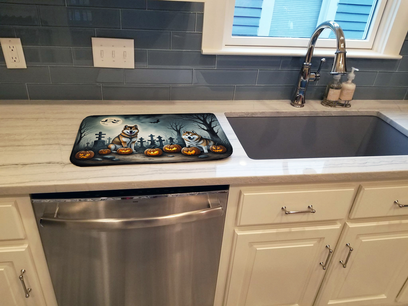 Halloween dish drying mat on the counter beside a kitchen sink
