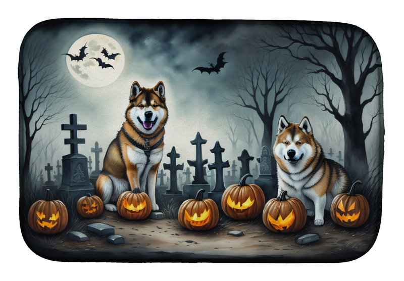 Halloween dish drying mat with two Akitas, pumpkins, and moonlit graveyard scene