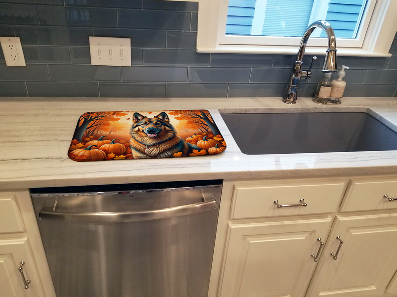Fall dish drying mat placed beside a kitchen sink with dog and pumpkin design