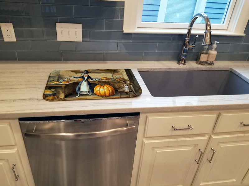 Pumpkin and dog illustrated dish drying mat laid across kitchen sink