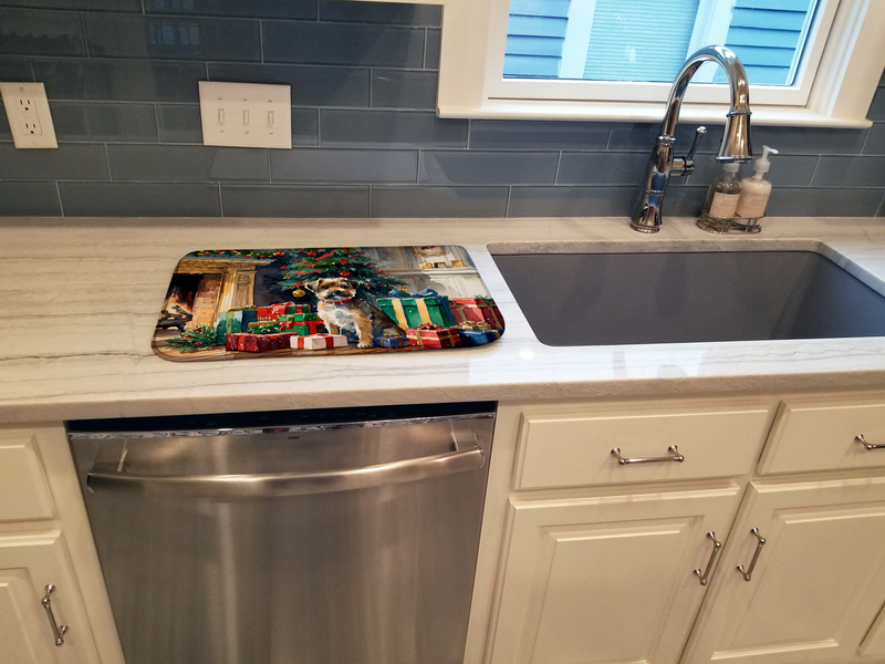 Holiday border terrier dish drying mat placed beside kitchen sink on countertop.
