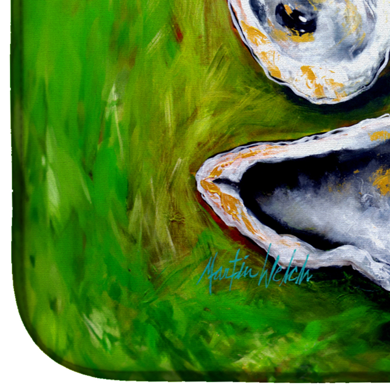 Green dish drying mat close-up with three oyster illustrations