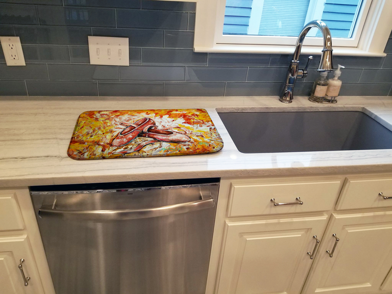 Dish drying mat with red-orange illustrated artwork on a kitchen countertop.