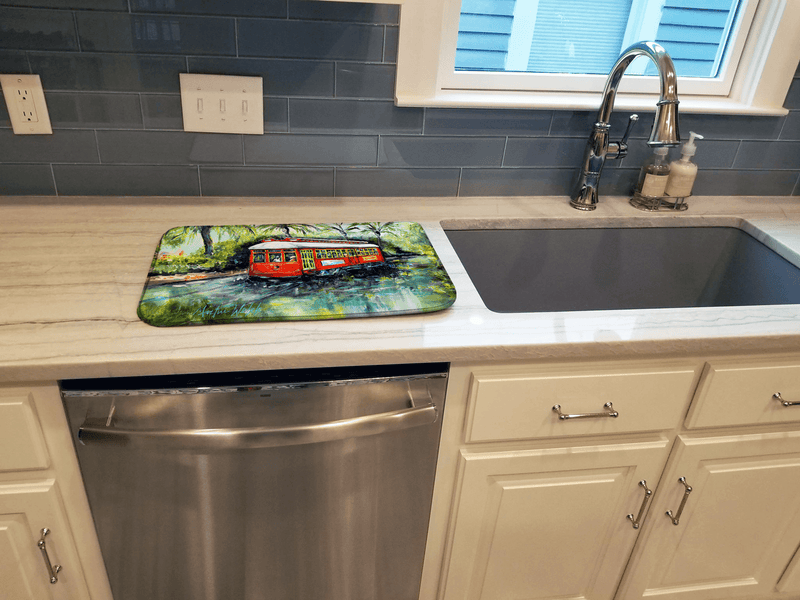 Dish drying mat on kitchen counter featuring red street car artwork on green-blue design