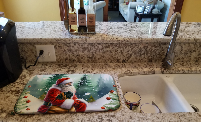 Santa and dog dish drying mat on kitchen counter near a stainless sink