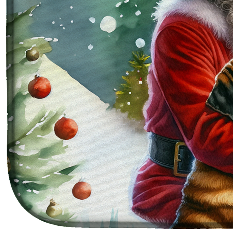 Dish drying mat corner with Santa in red holding a tray, snowy evergreen backdrop