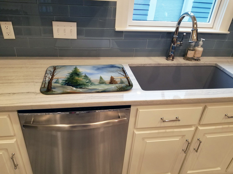 Christmas forest themed dish drying mat placed on kitchen counter