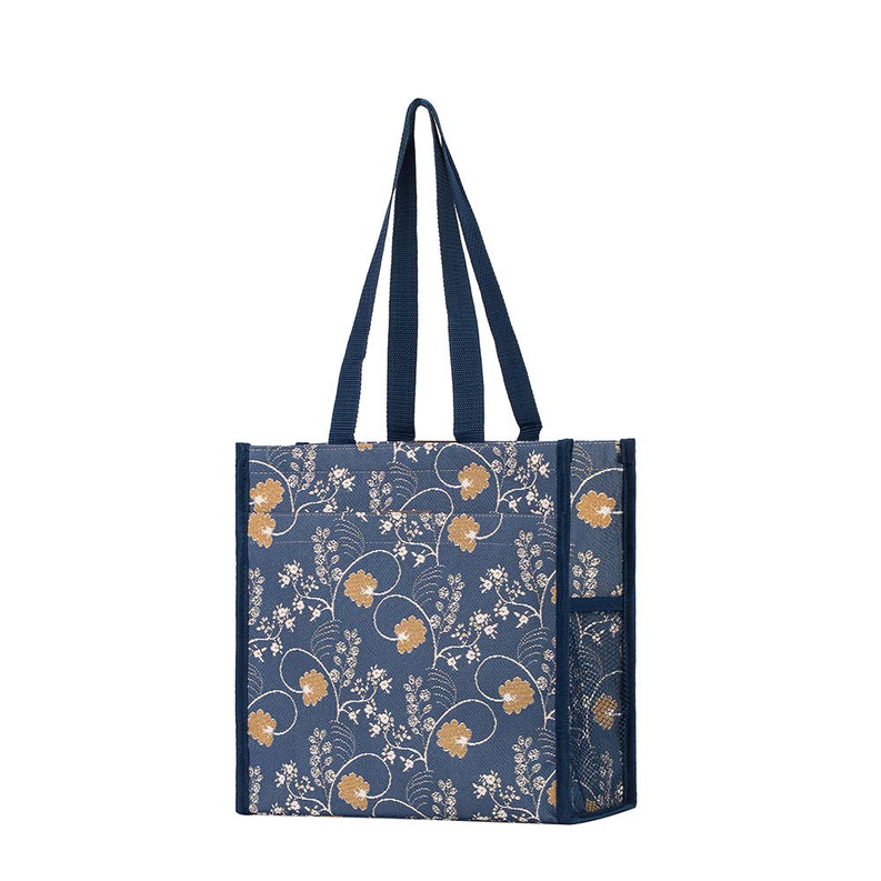 Blue floral tote shopper bag with two top handles and side slip pocket detailing.