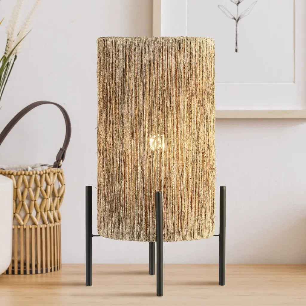 Woven natural fiber table lamp with black metal legs, adding a bohemian touch to modern decor.